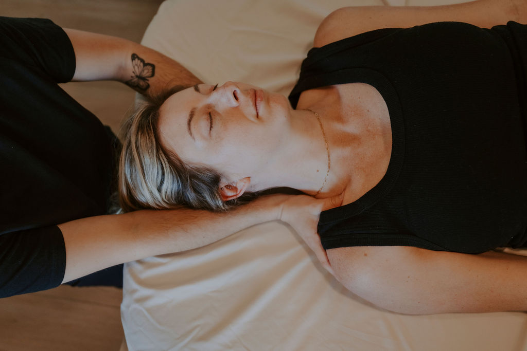 Women's therapeutic massage session addressing chronic tension and postpartum recovery at Wildflower Wellness